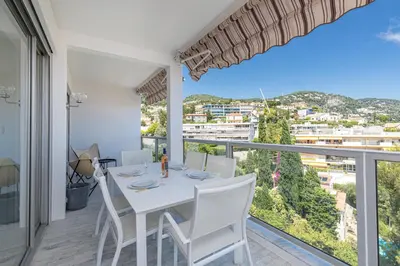 a dining room with a table and chairs and a large window at Sea View Park Swimming Pool & Tennis 2 Bdrs in Villefranche-sur-Mer