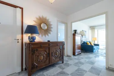 a living room with a table with a lamp and a couch at Sea View Park Swimming Pool & Tennis 2 Bdrs in Villefranche-sur-Mer