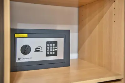 a microwave oven sitting inside of a cabinet at Home Inn - Centre ville - Nice in Nice