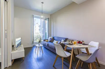a living room with a blue couch and a table at MY CASA - GAMBETTA 33 - 5min walk to beach in Nice