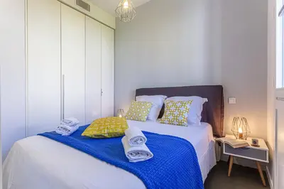 a bedroom with a bed with towels on it at MY CASA - GAMBETTA 33 - 5min walk to beach in Nice