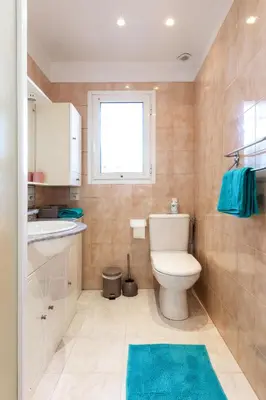 a bathroom with a toilet and a sink and a window at Observatoire in Nice