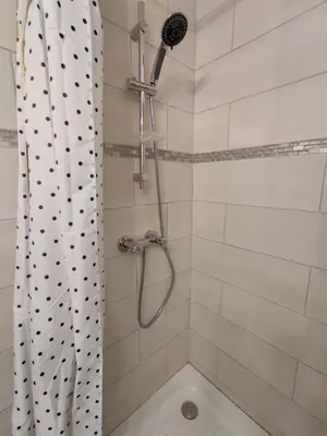 a bathroom with a shower with a shower curtain at L'Ambre d'Or in Falicon
