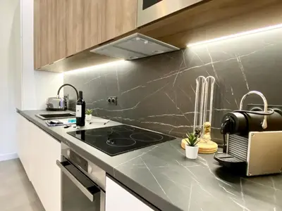 a kitchen with a sink and a counter top at Maxim - Easy Home Booking in Nice