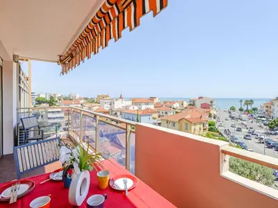 a living room and kitchen with a couch and a table at Apartment Etoile de Mer by Interhome in Cagnes-sur-Mer