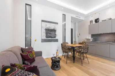 a living room with a couch and a table at Cosy Cocoon Place du Pin in Nice