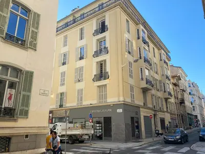 a large yellow building on a city street at LAMARTINE- Heart of Center- Modern and Design flat in Nice