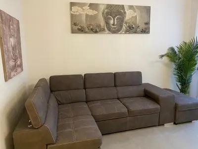 a brown leather couch in a living room at ZEN and Charming - Center -5 min walk to Sea- 2BR in Nice