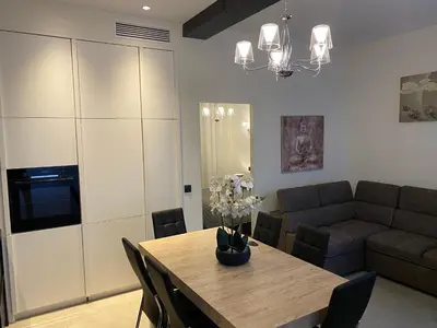 a living room with a table and a couch at ZEN and Charming - Center -5 min walk to Sea- 2BR in Nice