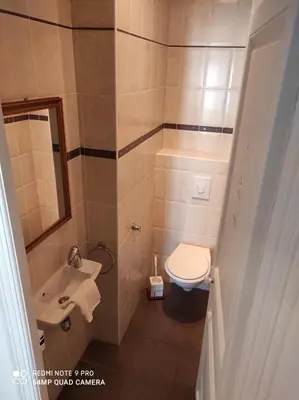a small bathroom with a toilet and a sink at Pretty and quiet top floor 2 bedroom flat in the port area of Nice in Nice