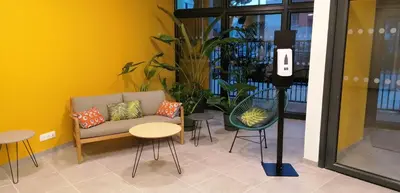 a room with a couch and some chairs and tables at PARME ETAPE in Nice