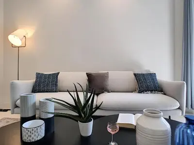 a living room with a couch and a table at Silver Beach Central 4pers Séjour 30jours Location éligible au Bail Mobilité Mobility Lease in Nice