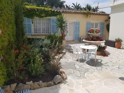 a patio with a table and chairs in front of a house at Hôtel de Charme Brise Marine in Saint-Jean-Cap-Ferrat