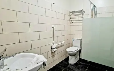 a bathroom with a toilet and a sink and a tub at Evelia Hotels in Nice