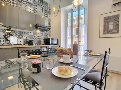 a kitchen with a table with plates of food on it at Nestor&Jeeves - VEGA GIOFFREDO - Hyper center - Close sea and Old Town in Nice