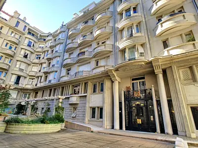 a large apartment building with a black door at Nestor&Jeeves - GLORIA BEACH - Very close sea - Prestigious building in Nice