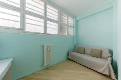 a living room with a couch and windows at Wonderful Apartment on Sea in Nice