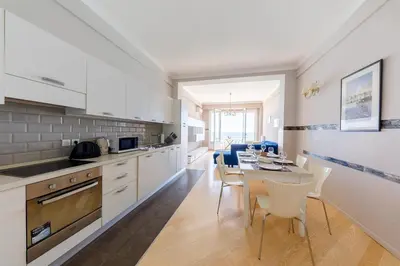 a kitchen and dining room with a table and chairs at Wonderful Apartment on Sea in Nice