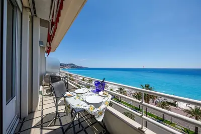 a balcony with a table and a view of the ocean at Wonderful Apartment on Sea in Nice