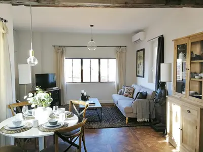 a living room with a table and a couch at COCOON LOFT - MAGNIFIQUE LOFT SOUS TOIT, REFAIT A NEUF, VUES SPLENDIDES, CLIM, WIFi in Nice