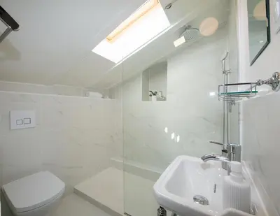 a white bathroom with a toilet and a sink at COCOON LOFT - MAGNIFIQUE LOFT SOUS TOIT, REFAIT A NEUF, VUES SPLENDIDES, CLIM, WIFi in Nice