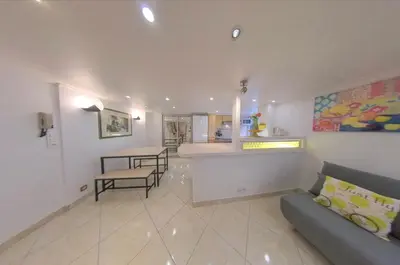 a living room with a couch and a kitchen at Cosy Duplex au Port du Vieux Nice in Nice