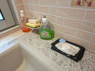 a bathroom counter with a sink and two bottles of soap at Cosy Duplex au Port du Vieux Nice in Nice