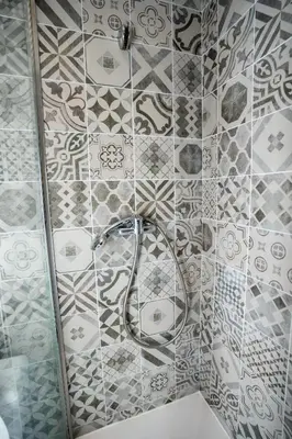 a shower with a hose on a tiled wall at Le Pastoral in Nice