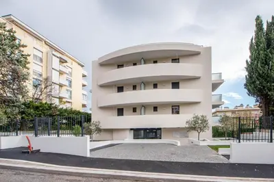 a white apartment building with a round window at Elegance in Nice