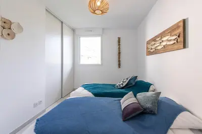 a bedroom with a bed with a blue blanket at Elegance in Nice