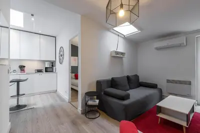 a living room with a couch and a table at Magenta Square Central 1 Bdr with AC in Nice
