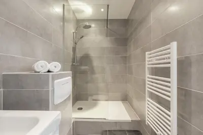 a bathroom with a shower and a sink at Magenta Square Central 1 Bdr with AC in Nice