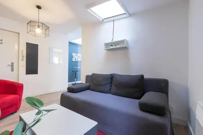 a living room with a couch and a red chair at Magenta Square Central 1 Bdr with AC in Nice