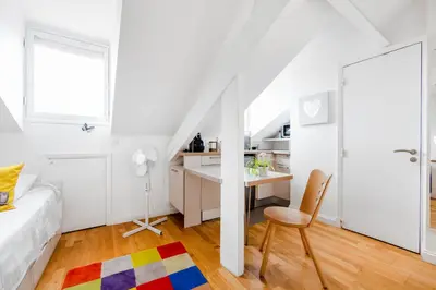 a bedroom with a bed and a desk and a chair at Studio on the Attic 3min from the Sea & Main street in Nice