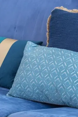 a blue bed with a blue pillow and blue pillows at MY CASA - FRANCK PILATTE - Beautiful Sea View - Near the Port in Nice