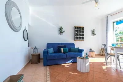 a living room with a blue couch and a table at MY CASA - FRANCK PILATTE - Beautiful Sea View - Near the Port in Nice