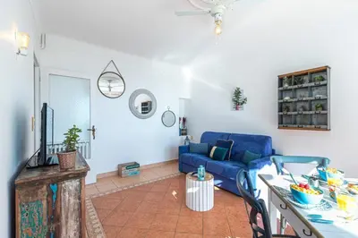 a living room with a blue couch and a table at MY CASA - FRANCK PILATTE - Beautiful Sea View - Near the Port in Nice