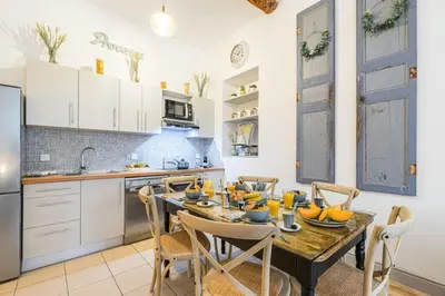 a kitchen with a table and chairs in a kitchen at MY CASA - GALLIENI - Superb & Unique in City Center in Nice