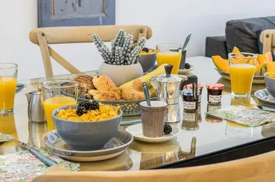 a table with breakfast foods and orange juice on it at MY CASA - GALLIENI - Superb & Unique in City Center in Nice
