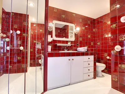 a red tiled bathroom with a toilet and a shower at Nestor&Jeeves - BEACH COTTAGE TERRACE - Central - Very close sea - Top floor in Nice