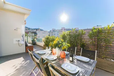 a table on a balcony with a view of the city at La Terrasse du Port AP4212 in Nice