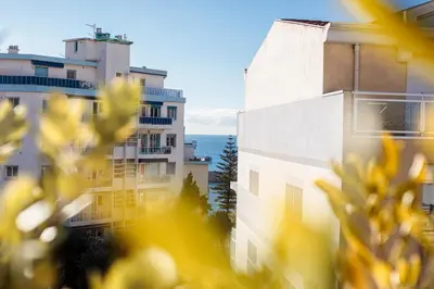 a view of a building with the ocean in the background at La Terrasse du Port AP4212 in Nice