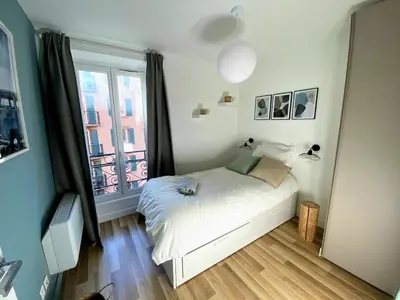 a small bedroom with a bed and a window at Sunny and calm 2 bed apartment place du Pin in Nice