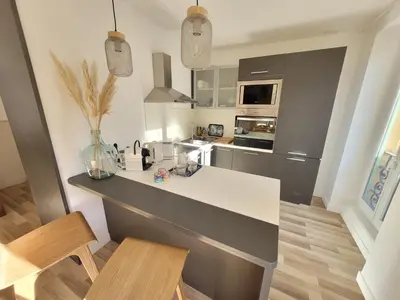 a kitchen with a white counter top in a room at Sunny and calm 2 bed apartment place du Pin in Nice