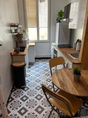 a kitchen with a table and chairs in a kitchen at Moderne, 2 chambres, 6 Couchages, EASY CHECK-IN in Nice