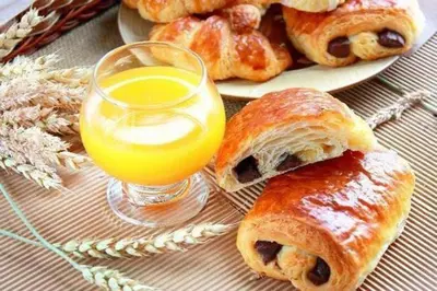 a plate of pastries and a glass of orange juice at ApartHotel Riviera - Hyper Centre Ville - Studio Supérieur AC avec balcon et aperçu mer - BALCON MASSENET 1 in Nice