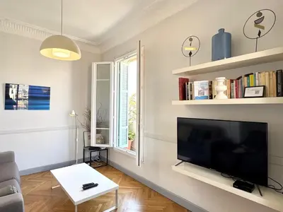 a living room with a large flat screen tv at ApartHotel Riviera - Hyper Centre Musiciens - Superior 1 Bedroom Apartement AC - Balcony - 10 mn Promenade des Anglais - BALCON PALAIS EXCELSIOR 1 in Nice