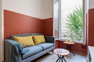 a living room with a couch and a window at Cosy and Trendy 3 Bedrooms train tramway in Nice