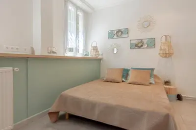 a bedroom with a bed with two pillows on it at Studio climatisé à 50m des plages in Nice