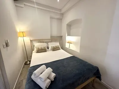 a bedroom with a bed with two towels on it at ApartHotel Riviera - Barillerie 12 - Vieille Ville 1mn plage - Appartement 2 pieces AC in Nice